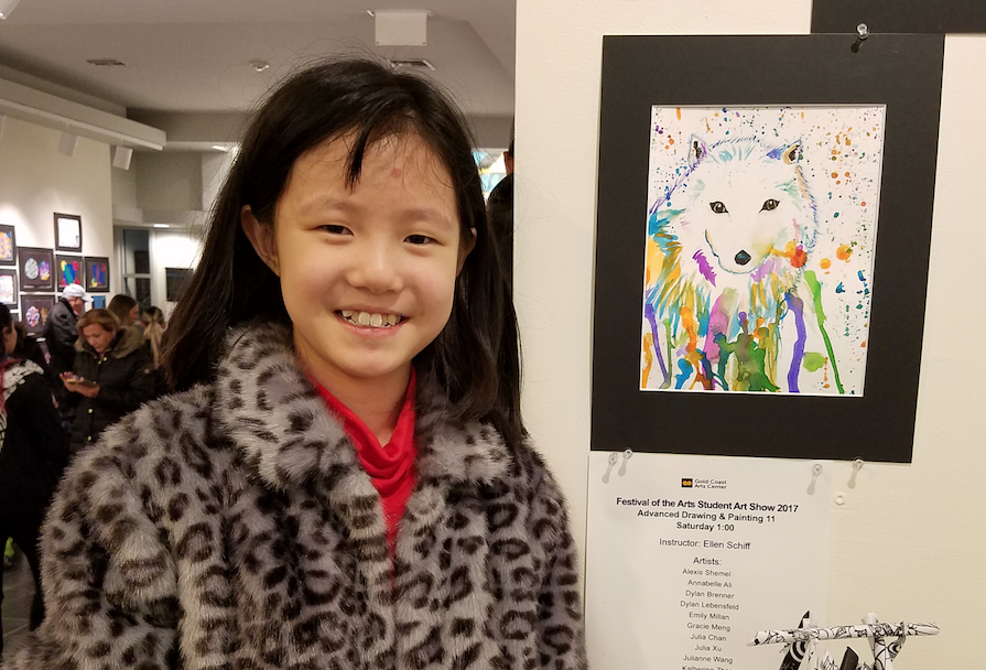 Katherine Zhao, 9, stands next to her work featured in the exhibit. (Photo by Janelle Clausen) 