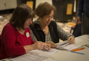 Jean Pierce and other poll workers had to check absentee ballots with documented signatures to ensure each of the hundreds of absentee ballots were legitimate. (Photo by Janelle Clausen) 