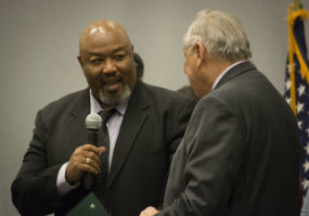 Timothy Thurmond, vice president of the Garden City Park Homeowners and Civic Association, speaks with Councilman Ferrara on stage. (Photo by Janelle Clausen)
