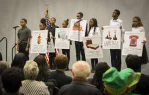 Students of Westbury Middle School took turns speaking about various black entrepreneurs and inventors, saying that "their success is our success." (Photo by Janelle Clausen)