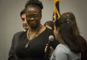 Adrienne Vaultz, an accountant and youth advocate, looks on as Councilwoman Anna Kaplan speaks about her. (Photo by Janelle Clausen)