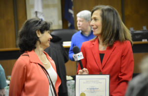 County Legislator Ellen Birnbaum of Great Neck interviews Suzanne Posner on Public Access Television as she presents her a commendation. (Photo by Janelle Clausen)