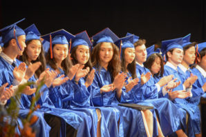 The front row of Great Neck South High graduates applauds after a speech. (Photo by Janelle Clausen)