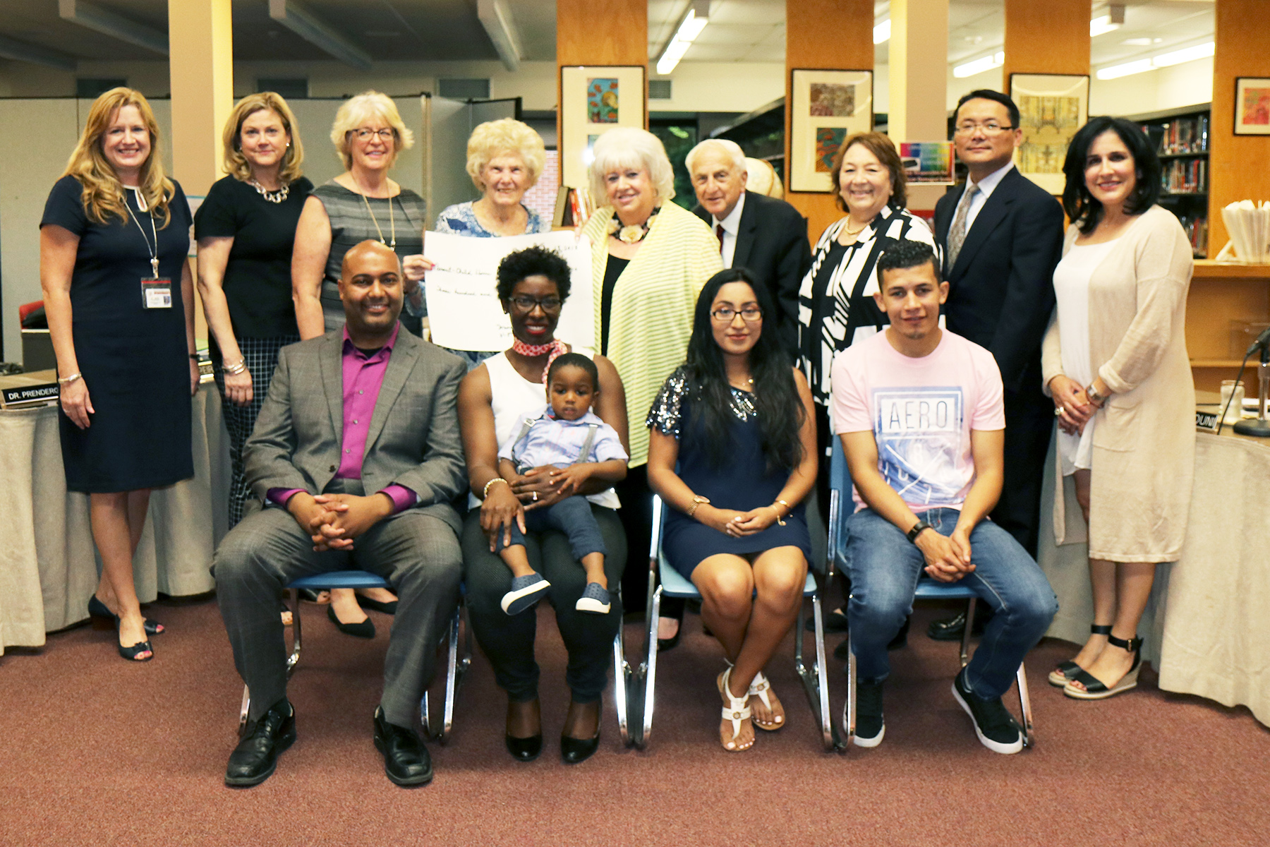 School administrators and board trustees joined PCHP lead teacher Suzanne Belmont, Program Coordinator Regina Farinaccio, and Miriam Chatinover of the NCJW, as well as families who benefitted from the program. (Photo courtesy of the Great Neck Public Schools)