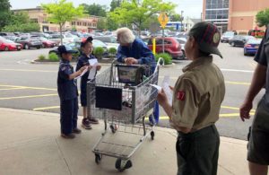 A group of cub scouts talk with a grocery shopper outside of King Kullen. (Photo by David Lau)