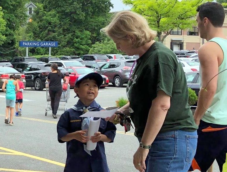 A scout approaches a shopper to try and get donations for the Ronald McDonald House. (Photo by David Lau)