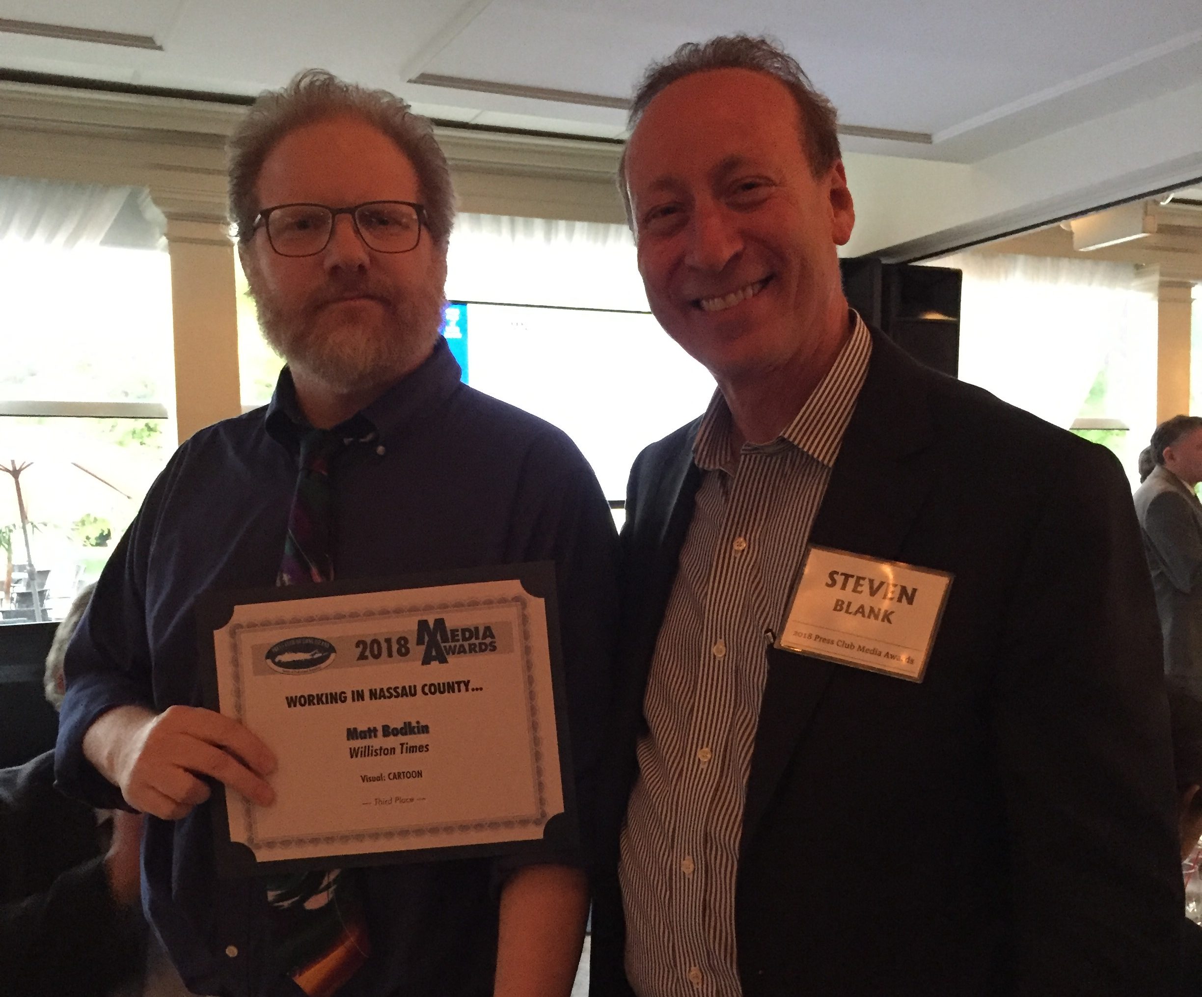 Editor and publisher Steve Blank poses for a photo with Matt Bodkin, who won third place for best editorial cartoon. (Photo courtesy of Steve Blank)
