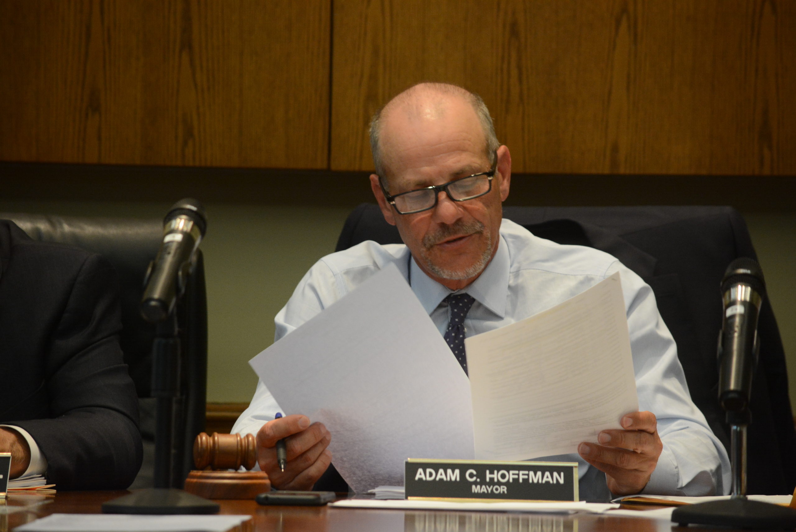 Mayor Adam Hoffman reviews a set of documents during Monday night's board meeting. (Photo by Janelle Clausen)