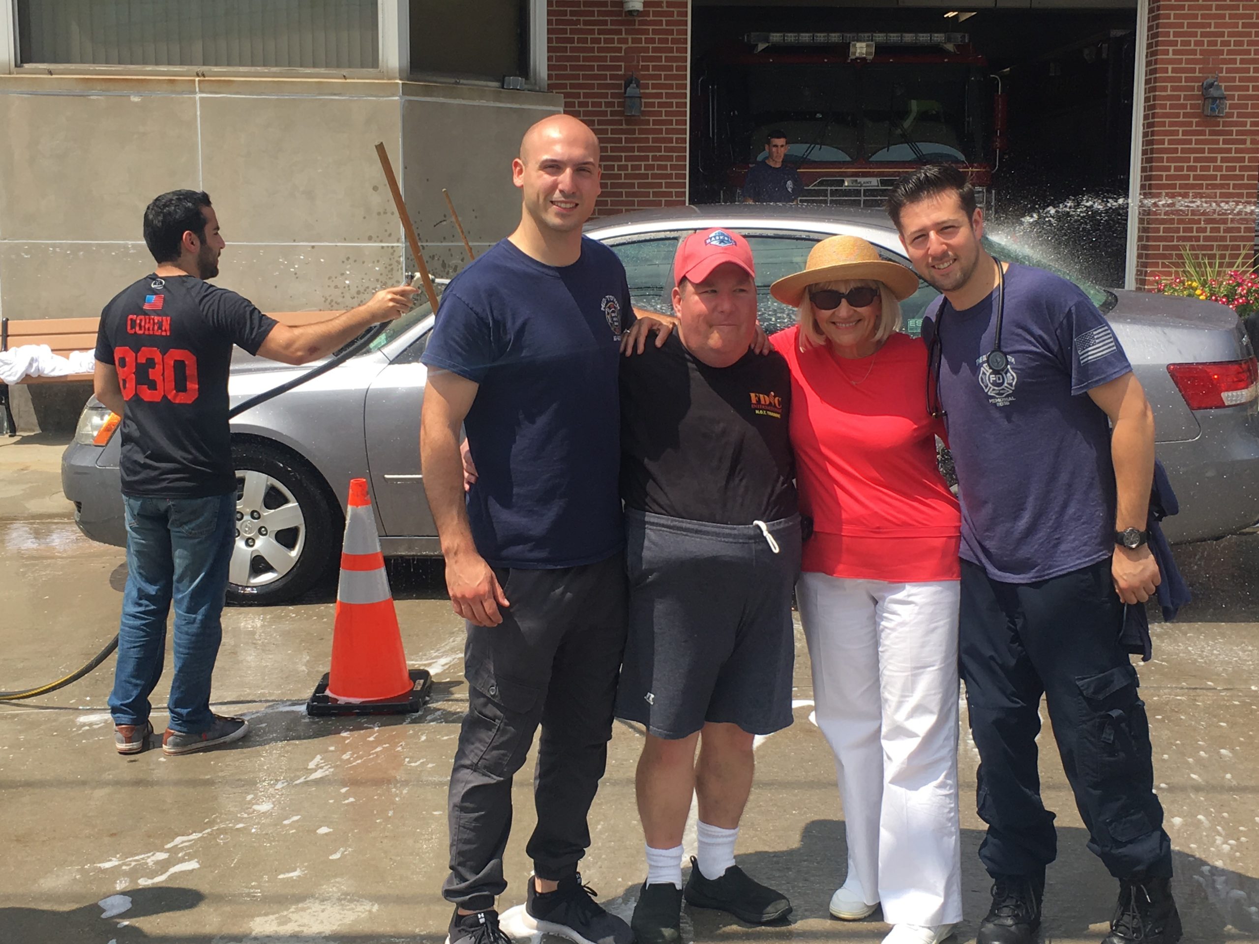 First Assistant EMS Chief Joseph Oginsky, Erin Lipinsky, Supervisor Judi Bosworth and Steve Shapiro at a car wash benefiting Special Olympics New York. (Photo courtesy of the Town of North Hempstead)