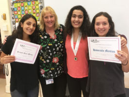 Alexis Namdar, Madison Kokhavim, and Ariella Edelman of North High School are congratulated by American Sign Language teacher Kathy McAleer. (Photo courtesy of Great Neck Public Schools)