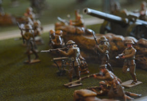 Martin Neville, a retired lieutenant, loaned a set of miniature soldiers to the library. "I'm told that's been the most interesting exhibit for the little kids that come to the library," he said. (Photo by Janelle Clausen)