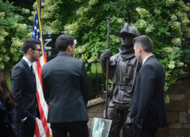 Memorial service attendees gather around the statue of Ielpi, which doubles as a memorial ground for other fallen firefighters. (Photo by Janelle Clausen)