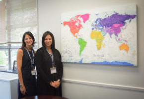 Sara Goldberg and Luciana Bradley pose for a photo in front of the world map. (Photo by Janelle Clausen)