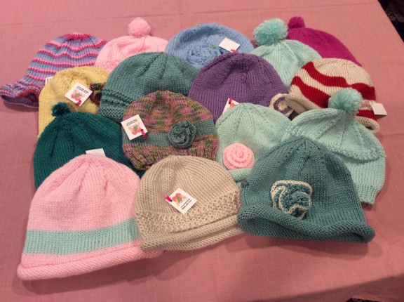 Hats knit by volunteers bring comfort and warmth to persons in need. (Photo by Desiree Shar)