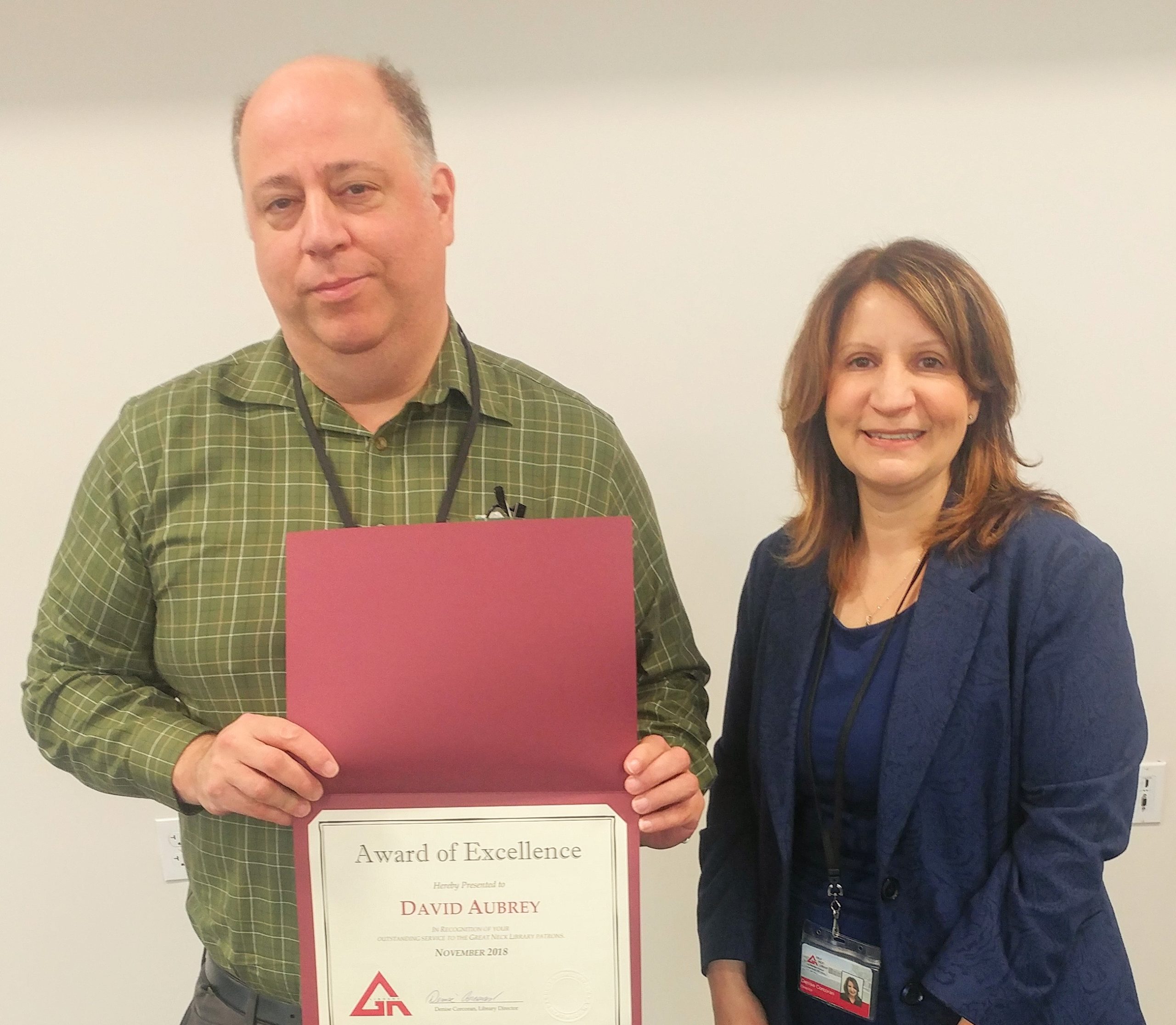 David Aubrey receives the Great Neck Library Staff Excellence Award for November 2018 from Library Director Denise Corcoran. (Photo courtesy of the Great Neck Library)