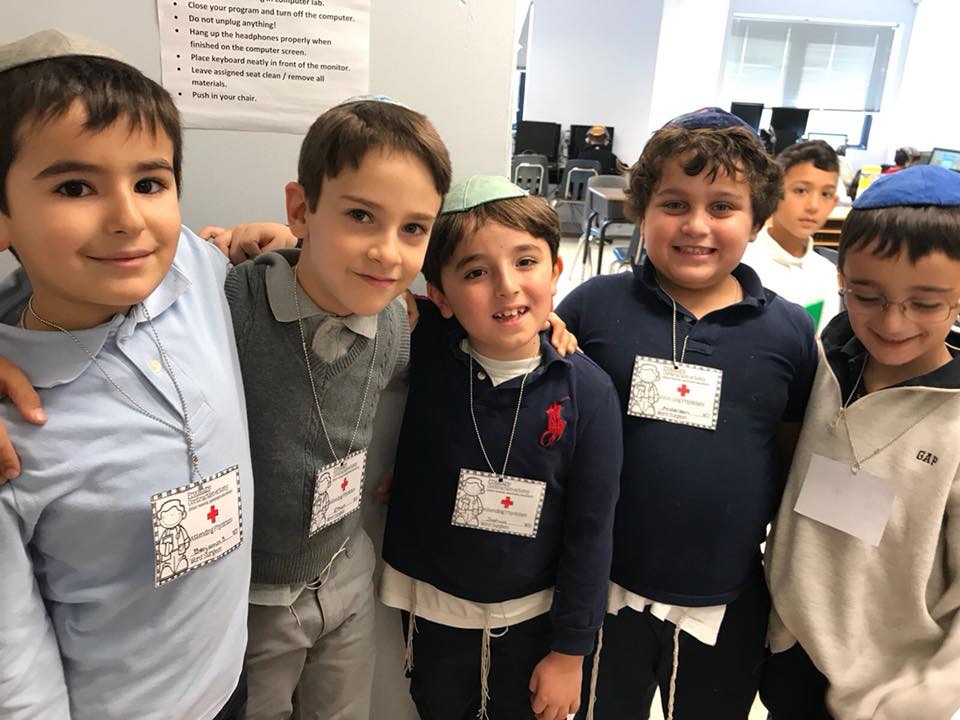 Silverstein Hebrew Academy second graders with their medical badges after they performed their contraction surgeries. (Photo courtesy of Silverstein Hebrew Academy)