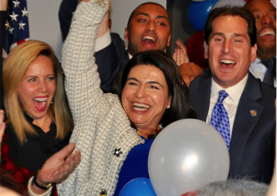 Anna Kaplan, flanked by Hempstead Supervisor Laura Gillen and state Sen. Todd Kaminsky, is declared the victor of the state Senate District 7 race at the Democrats' election party in Garden City. (Photo by Luke Torrance)