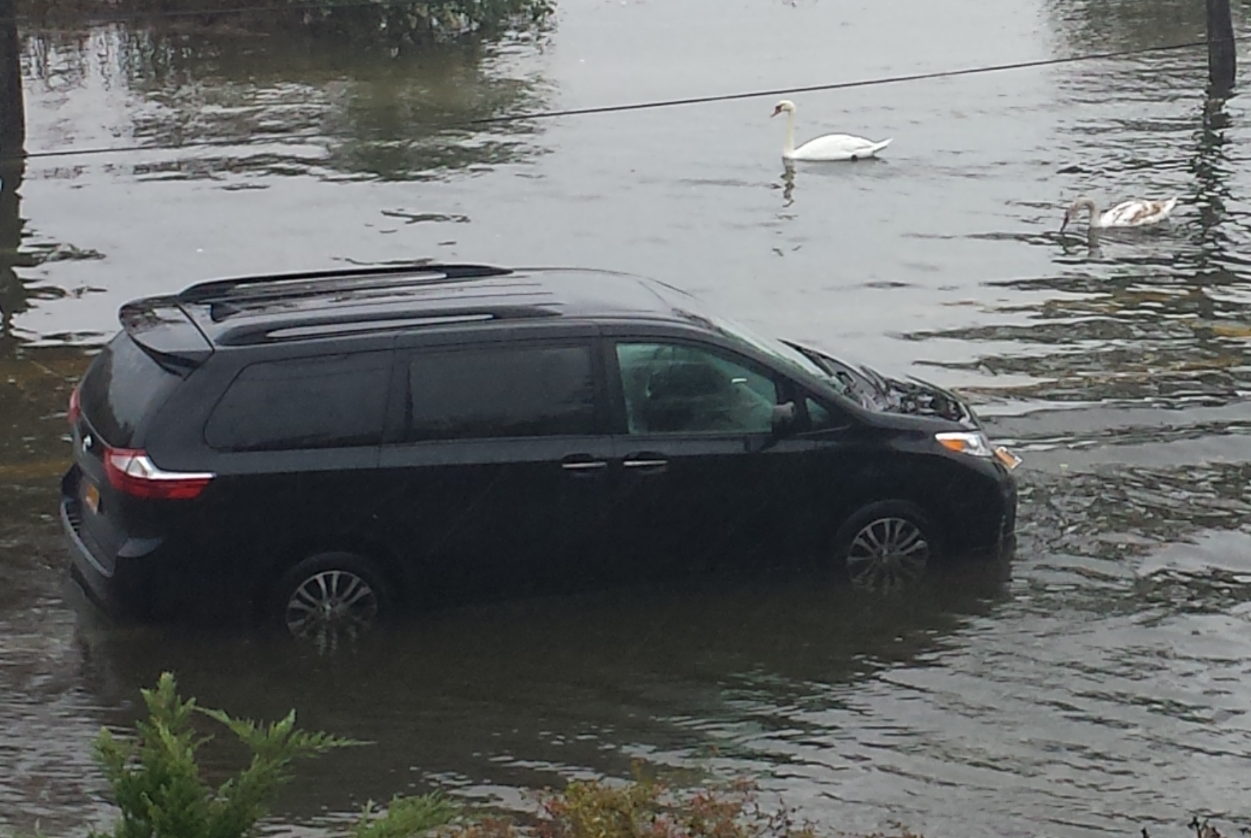 A van flooded when attempting to drive on Shore Road during a recent rainstorm. (Photo courtesy of Baxter Estates resident Maria Branco)