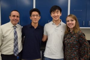 Richard Lee and Kendrick Tak pose with their advisor Alison Huenger and Thomas Elkins, Manhasset's district coordinator for science, health and technology. (Photo by Terry Gilberti)
