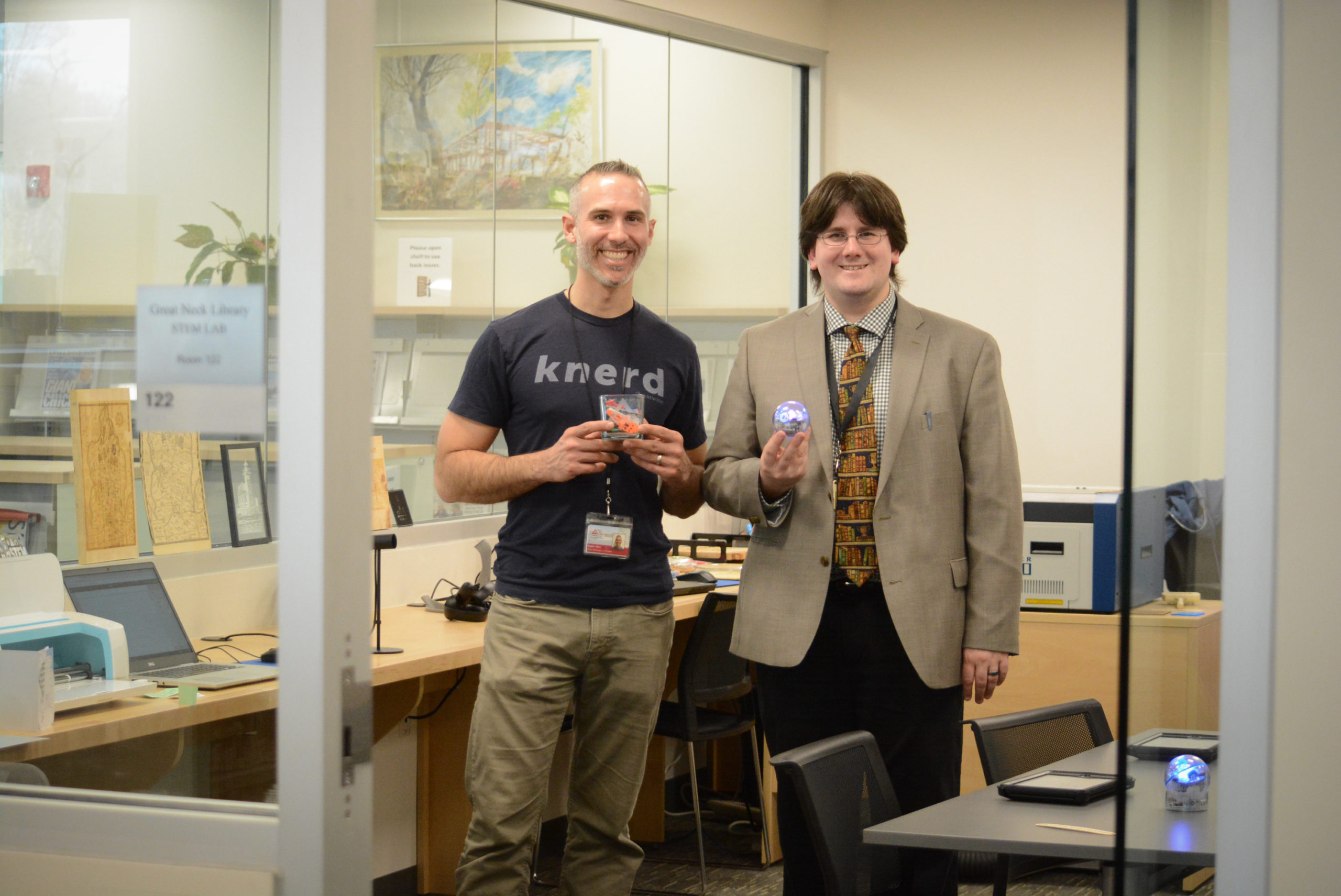 Adam Hinz and Christopher Van Wickler show off some of the objects created in the library's new STEM lab. (Photo by Janelle Clausen)