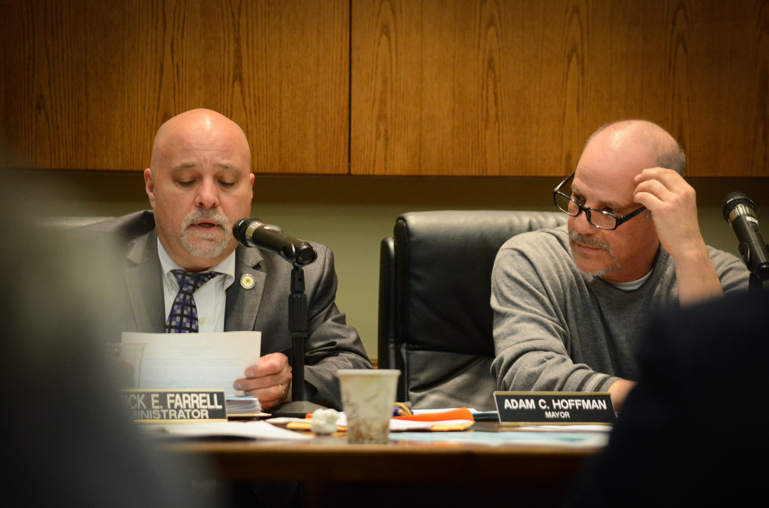 Lake Success Village Mayor Adam Hoffman looks on as Village Administrator Pat Farrell reads a resolution regarding ExteNet Systems. (Photo by Janelle Clausen)