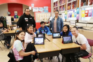 Fifth graders in Ms. Ayende’s class learn about photo editing and graphic design from Brandon Ayende as part of the Lakeville School’s annual Teach-In event. (Photo courtesy of Great Neck Public Schools)