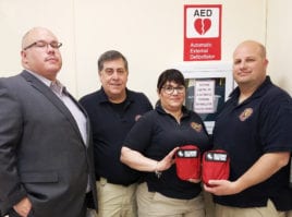 Richard Castro from the Great Neck Public Schools security department is photographed with representatives from the Nassau County Fire-Police EMS Academy following a recent training at the Phipps Administration Building. Bleeding control kits, shown here, are located in all GNPS buildings and vehicles. (Photo courtesy of Great Neck Public Schools)