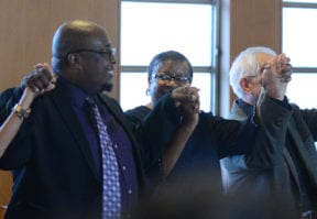 Attendees joined hands to form a "circle of love" as they sang "We Shall Overcome" together. (Photo by Janelle Clausen)